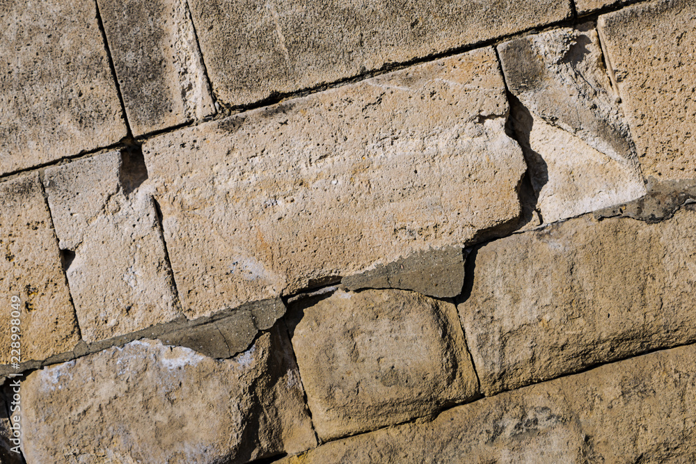 Fototapeta premium base stone oblique large rectangular cobblestone close-up light gray background design wall fort