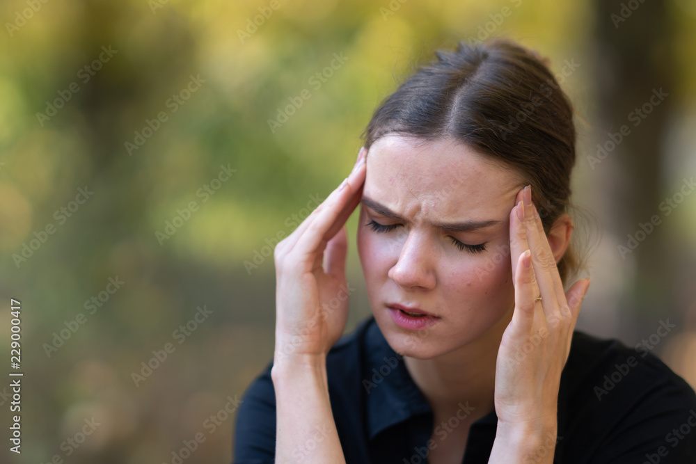 Young woman with headache, pain, or worries Young woman with headache, pain, or worries