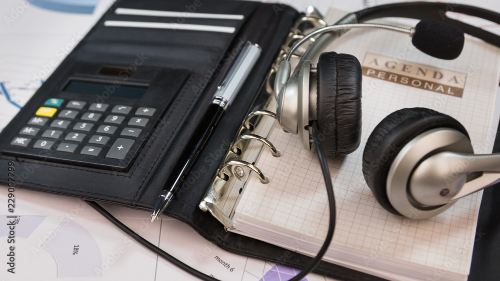 Close-up, headset lying on an organizer notepad. Close-up, headset lying on an organizer notepad.
