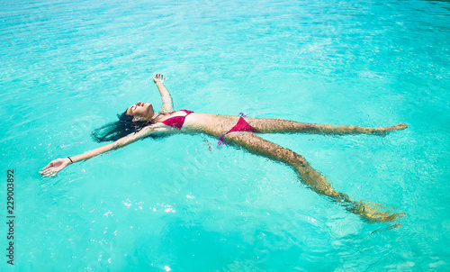 Beautiful girl swiming  at tropical Olhuveli island  south Male Atoll  Maldives.