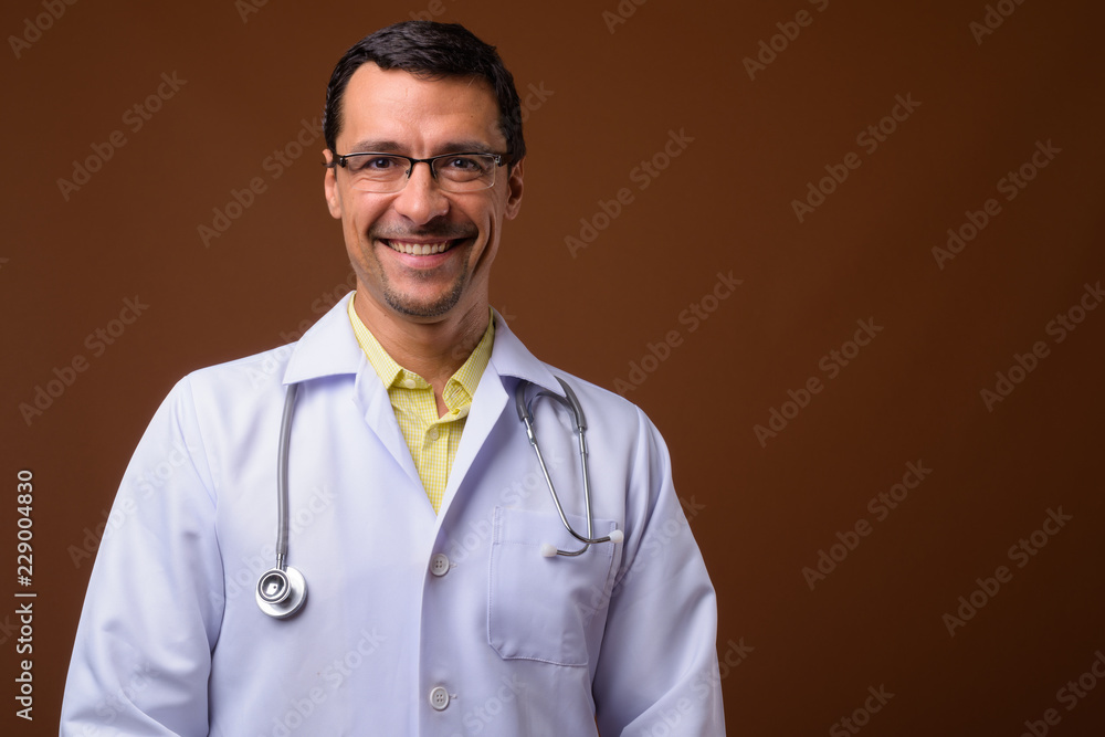 Portrait of happy man doctor smiling and looking at camera Portrait of happy man doctor smiling and looking at camera