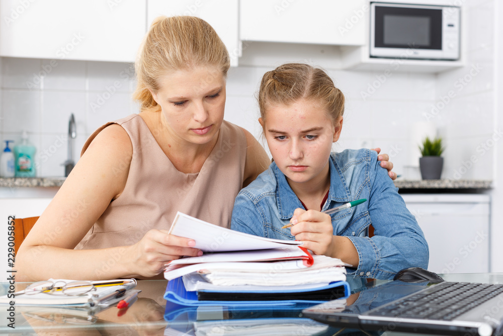 Fototapeta premium Woman supporting her upset daughter