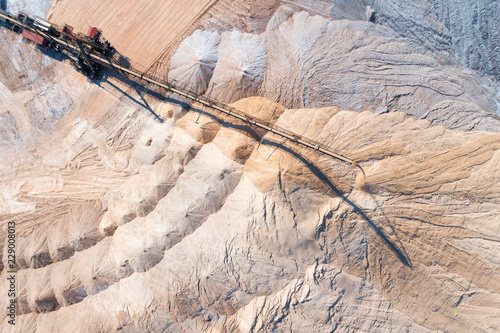 Spreader in the process of work. Transportation of an empty rock to a dump photo