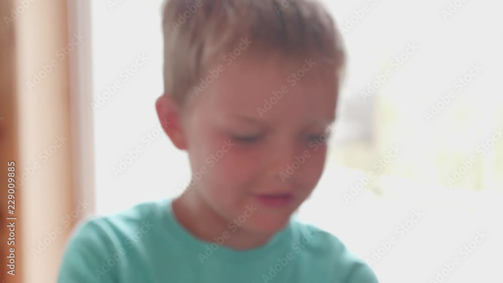 Little Boy Makes Tall Tower With Building Blocks In The Living Room At Home Little Boy Makes Tall Tower With Building Blocks In The Living Room At Home