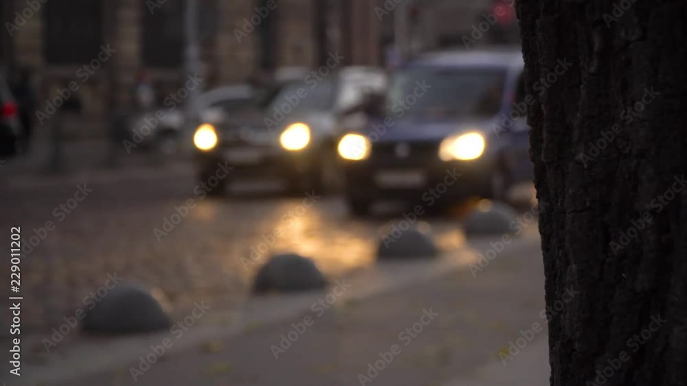 Road traffic. The movement of cars in the night city. Headlight light. Evening city. Road traffic. The movement of cars in the night city. Headlight light. Evening city.