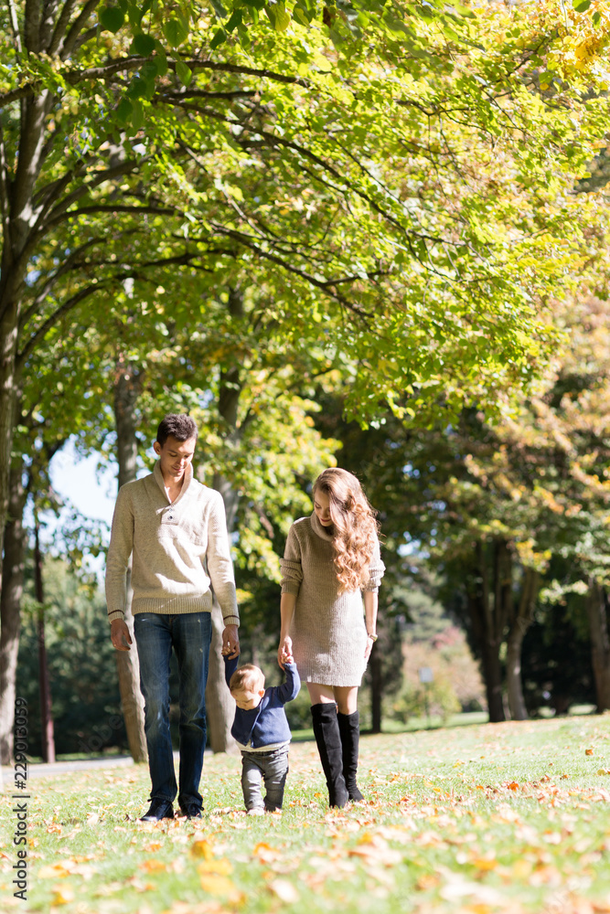 Fototapeta premium family with a baby in autumn park