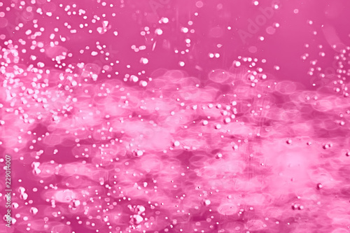 pink water bubbles background / fresh summer background pink air bubbles in water