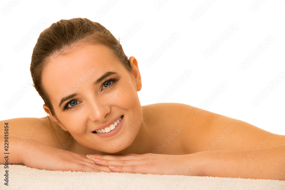 Skin care - beauty portrait of cute caucasian woman lying on table covered with white towel Skin care - beauty portrait of cute caucasian woman lying on table covered with white towel