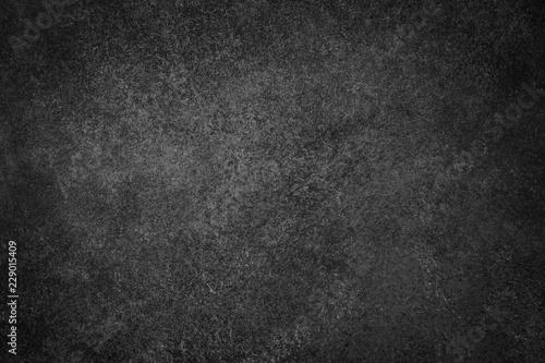 Dark black slate background. Stone or concrete surface