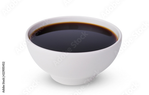 A tasty black soy sauce in bowl isolated on white background