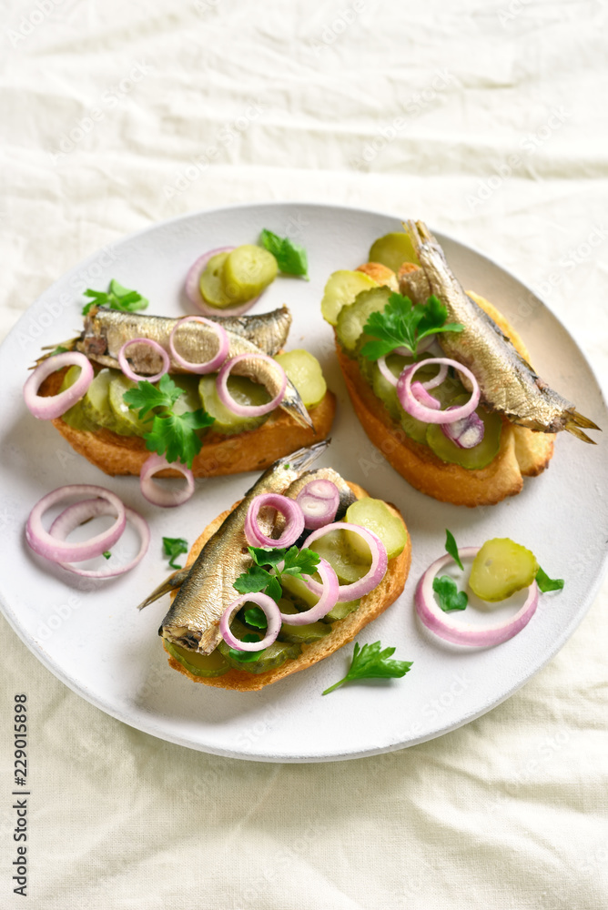 Sandwiches with sprats, marinated cucumber and onion Sandwiches with sprats, marinated cucumber and onion
