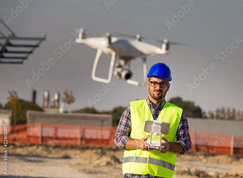 Engineer with drone at building site