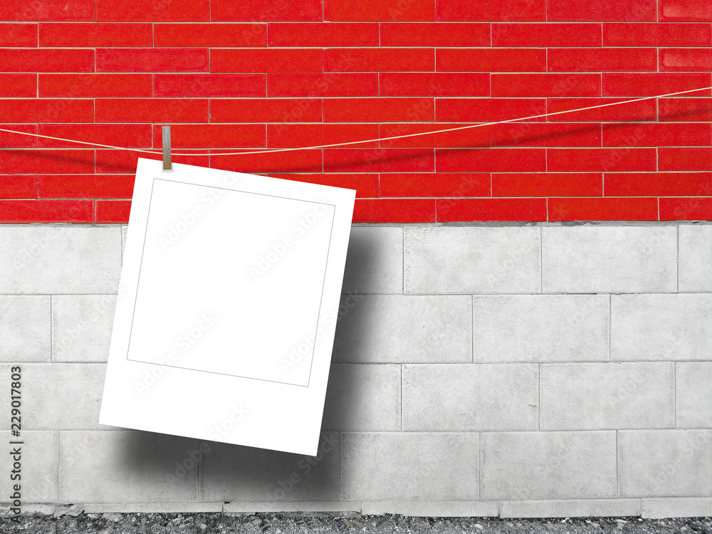 Blank square instant photo frame against red and white brick wall background Blank square instant photo frame against red and white brick wall background