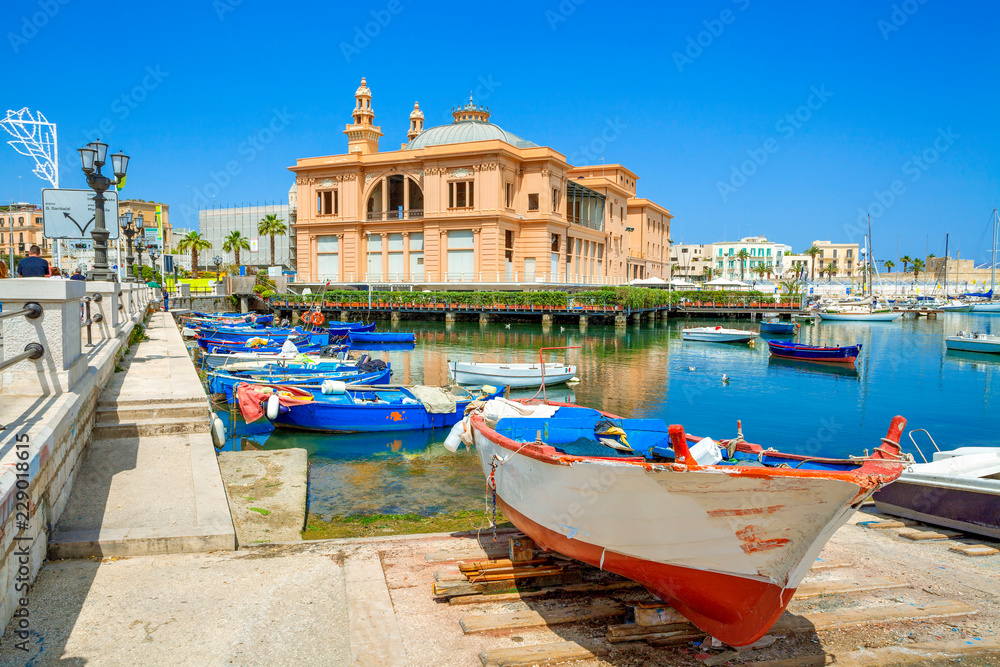 Margherita Theater and fishing boats in old harbor of Bari, Puglia, Italy. Bari is the capital city of the Metropolitan City of Bari on the Adriatic Sea, Italy. Architecture and landmark of Italy