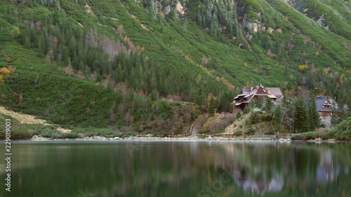 Tourist shelter on the shore of a mountain lake, a trip with a backpack, Polish containers