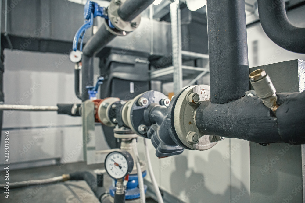 Fototapeta premium House heating system with many steel pipes, manometers and metal tubes