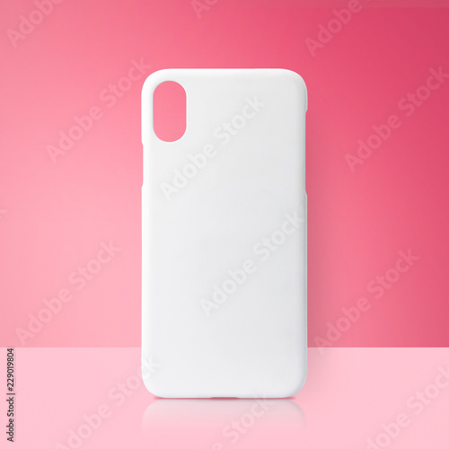 Fotografie White mobile cover on pink backdrops