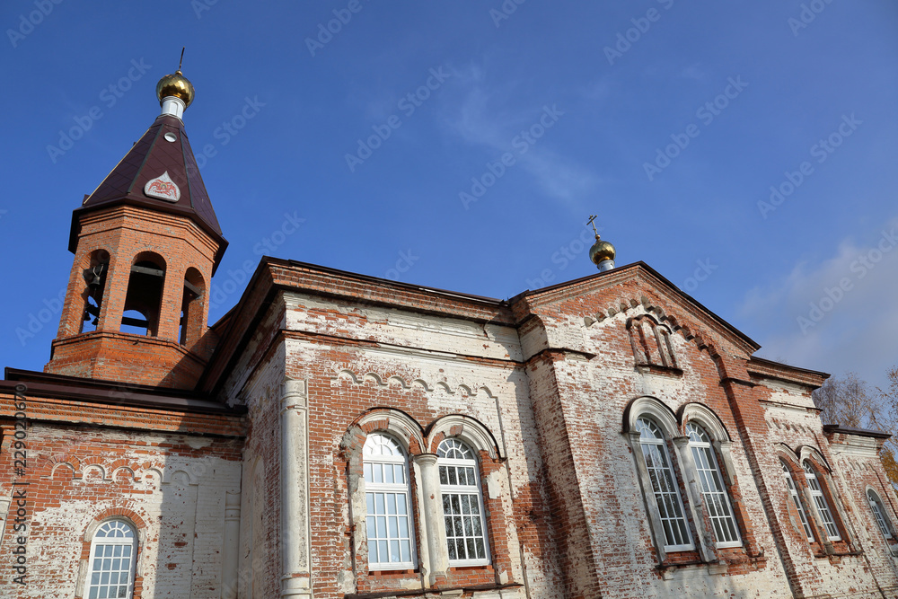 Brick single-altar single-headed Church of the Life-Giving Trinity with a bell tower in Konchezero. Founded in the 19th century. Karelia, Russia
