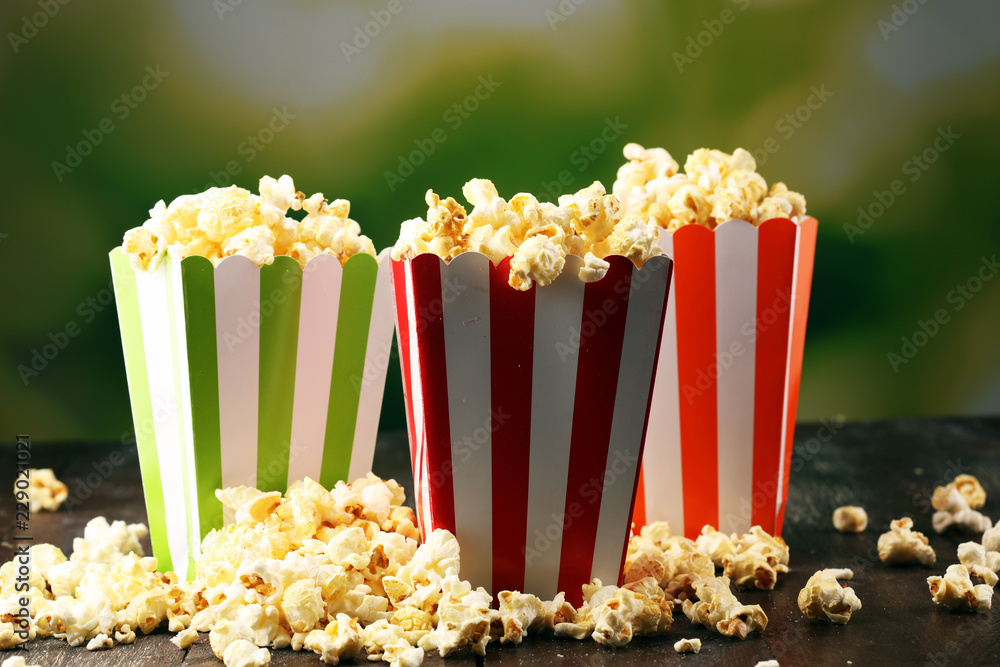 Cinema concept with popcorn in green white bag.