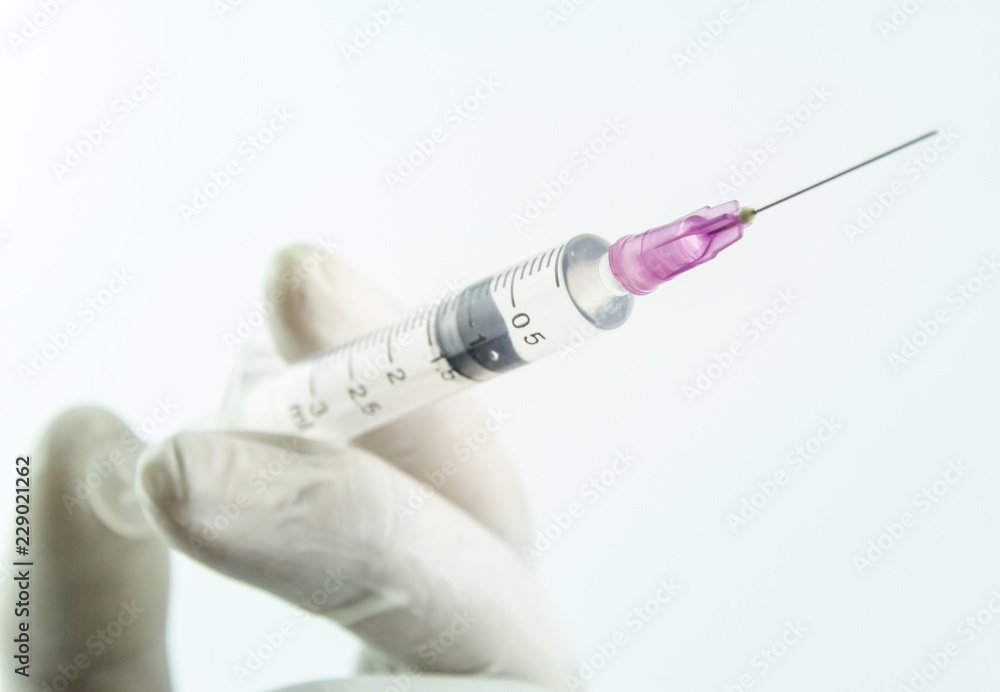 Medical syringe on hand a doctor. on white background Medical syringe on hand a doctor. on white background