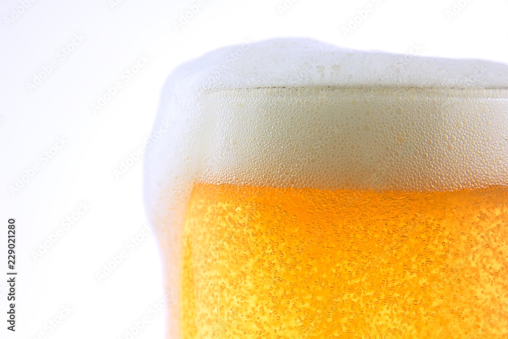 Pouring beer with bubble froth in glass on withe background. Pouring beer with bubble froth in glass on withe background.