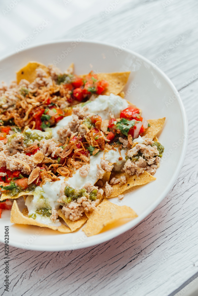 Fusion food Soboro Chicken Nachos: Japanese-style stir-fried chicken with tomato salsa, yogurt and Thai-style seafood sauce. Fusion food Soboro Chicken Nachos: Japanese-style stir-fried chicken with tomato salsa, yogurt and Thai-style seafood sauce.