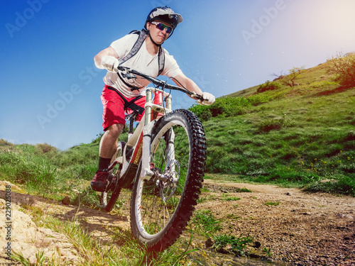 Mountain bike. Cyclist rides a bicycle down. Downhill sports.