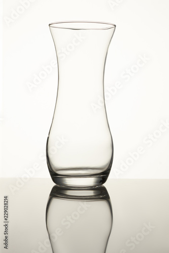 Clear glass vase isolated on a white background. Close up. Empty glass. photo