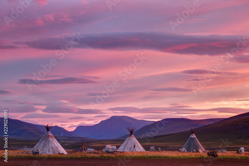 Morning landscape with dwellings of nomadic reindeer herders at sunrise. Russia