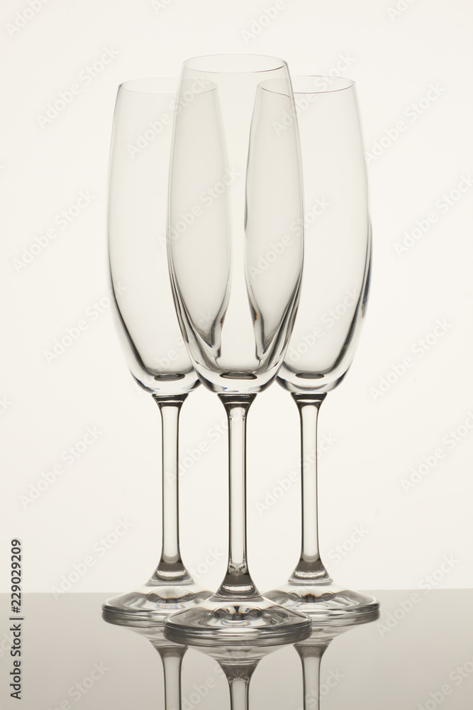 Three glass champagne cups. White background.
