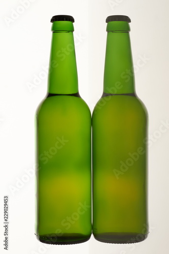Two green beer bottles. White isolated background.