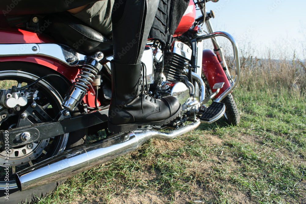 the details. Close portrait of leather boots on a motorcycle pedal, bike. Bikers. the details. Close portrait of leather boots on a motorcycle pedal, bike. Bikers.