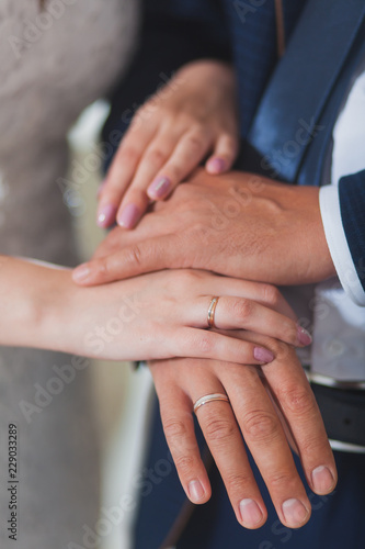Young married couple holding hands at a wedding ceremony