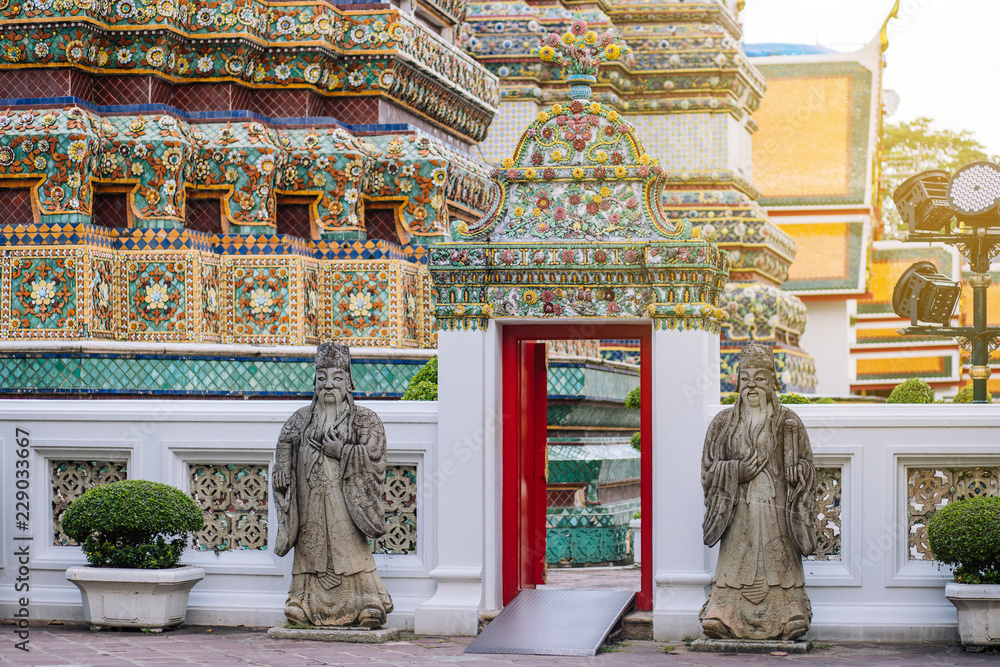 Chinese male angel statues at the gate in Wat Pho temple 