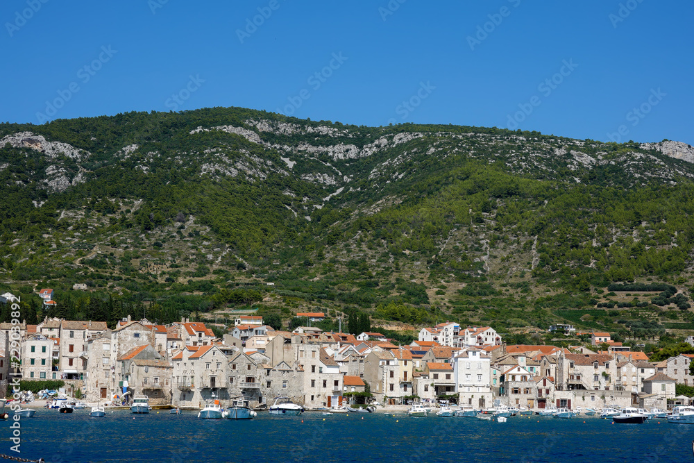Komiza, Croatia, July 27, 2018: Komiza, a Croatian town with 17th and 18th century stone town houses, on the western coast of the island of Vis, at the foot of the Hum hill.