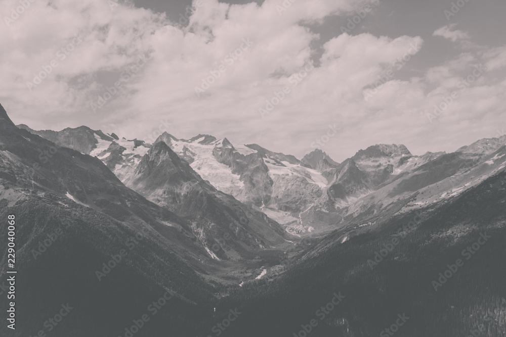 Obraz premium Closeup view mountains scenes in national park Dombai, Caucasus, Russia, Europe. Summer landscape, sunshine weather, dramatic blue sky and sunny day