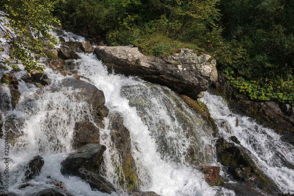 Closeup view waterfall scenes in mountains, national park Dombai, Caucasus, Russia, Europe. Summer landscape, sunshine weather and sunny day Closeup view waterfall scenes in mountains, national park Dombai, Caucasus, Russia, Europe. Summer landscape, sunshine weather and sunny day