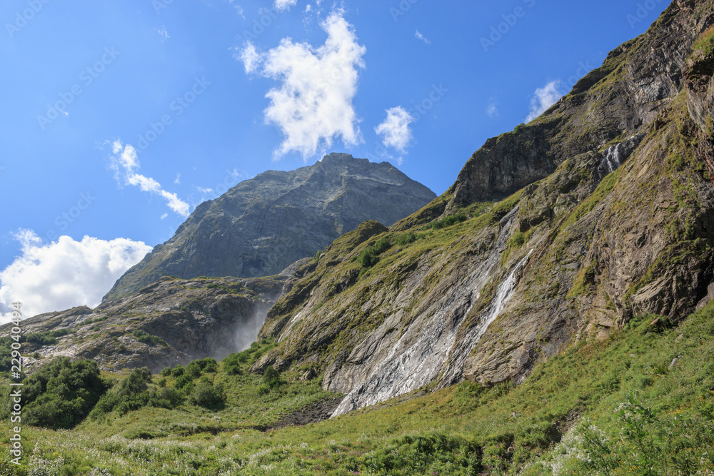 Closeup view mountains scenes in national park Dombai, Caucasus, Russia, Europe. Summer landscape, sunshine weather, dramatic blue sky and sunny day