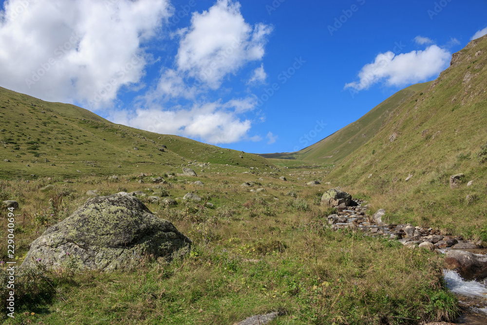 Closeup view mountains scenes in national park Dombai, Caucasus, Russia, Europe. Summer landscape, sunshine weather, dramatic blue sky and sunny day