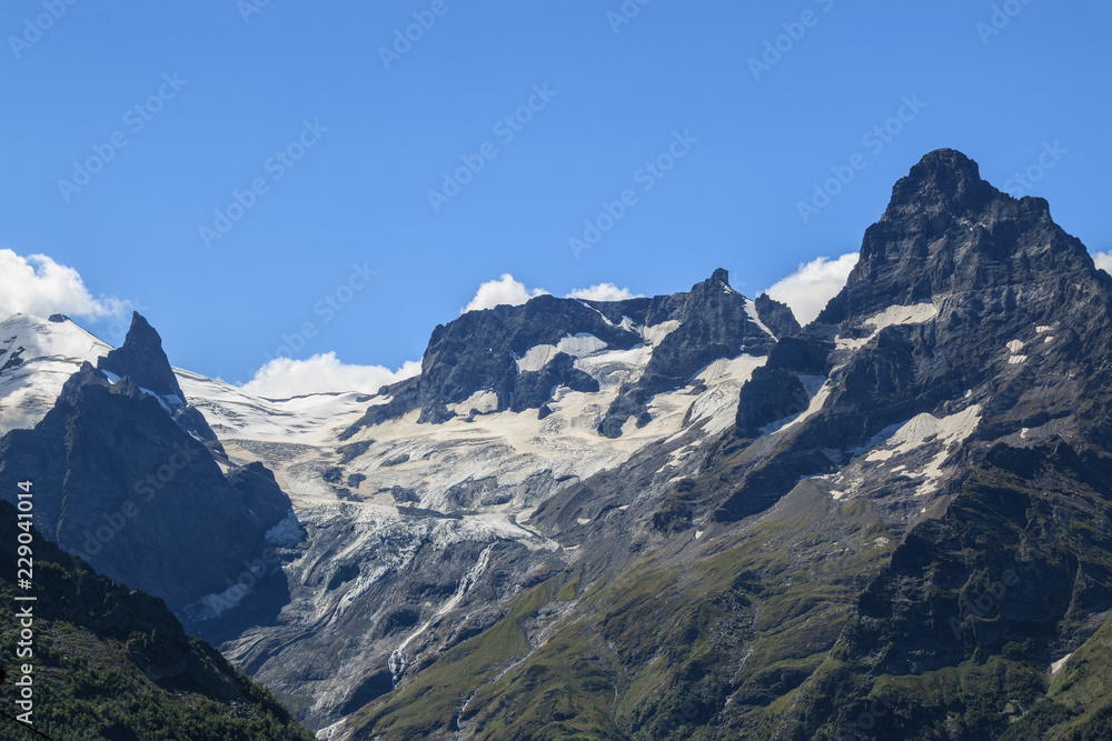 Closeup view mountains scenes in national park Dombai, Caucasus, Russia, Europe. Summer landscape, sunshine weather, dramatic blue sky and sunny day