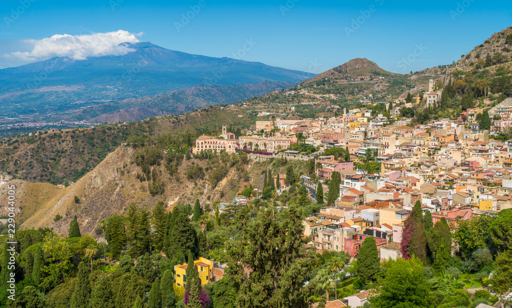 Panoramic sight with Taormina and Etna volcano, from the Ancient Greek Theater. Province of Messina, Sicily, southern Italy.