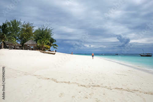 Delightful Kendwa beach view White man walking on the beach