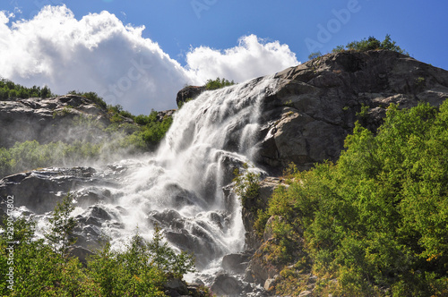 Waterfall scenes in mountains  national park Dombai  Caucasus  Russia  Europe. Sunshine weather and blue sky  summer day