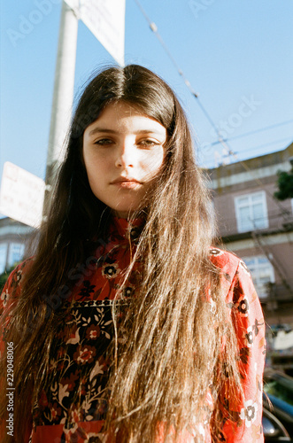 Portrait of brunette teenage girl standing outdoors