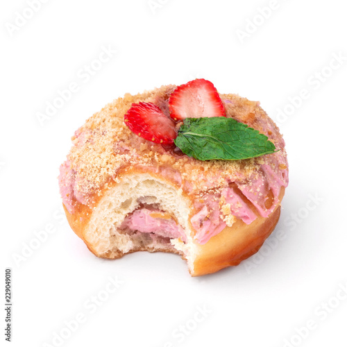 Donut with pink cream with nuts and strawberries. View from a forty-five degree angle. Isolated image. The side-bite donut.