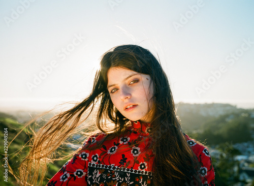 Portrait of brunette teenage girl standing outdoors