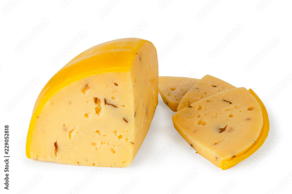 Cheese in wax shell cut into pieces on a white, isolated.