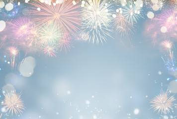 Fireworks colorful explosions on blue, festive background with copy space