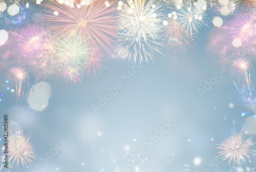 Fireworks colorful explosions on blue  festive background with copy space