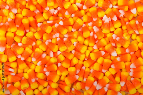 Background top view flat lay of candy corn. Candy corn is a candy most often found in the United States and Canada, popular primarily around Halloween